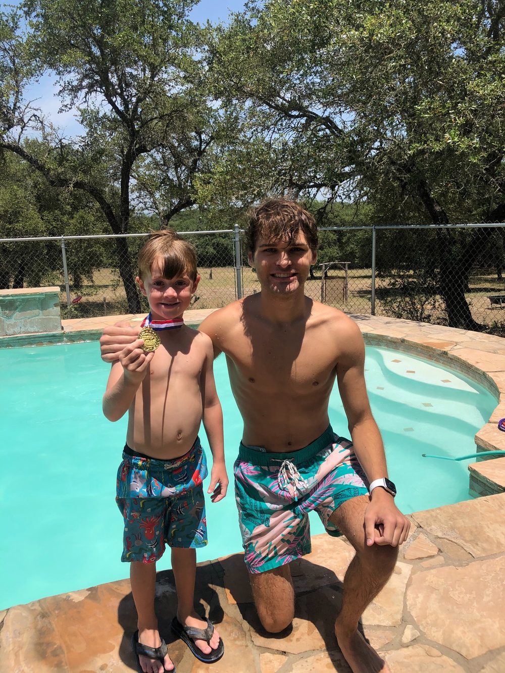 Coach Luke with a swimmer he coached at a pool